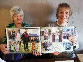 DG Moira Penney and President Nicki Little admire the photo album 